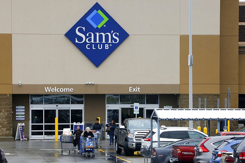 File- This Feb. 23, 2018, file photo shows shoppers leaving a Sam's Club in Pittsburgh.