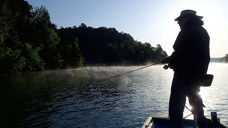 Dwayne Culmer fishes for black bass on a cool May morning at Beaver Lake. Culmer uses plastic worms to catch the three species of black bass, which are largmouth, smallmouth and spotted bass. Spotted bass are the subject of a study being conducted statewide by the Arkansas Game and Fish Commission. 
(NWA Democrat-Gazette/Flip Putthoff)