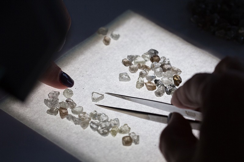 An employee sorts a collection of rough diamonds at the United Selling Organisation of Alrosa PJSC sorting center in Moscow. MUST CREDIT: Bloomberg photo by Andrey Rudakov