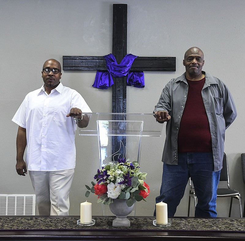Minister Andre Dunson, left, and the Rev. James C. Lowery stand at the pulpit of New Covenant Church Of God In Christ, 113 Buena Vista Road, on Thursday. - Photo by Grace Brown of The Sentinel-Record