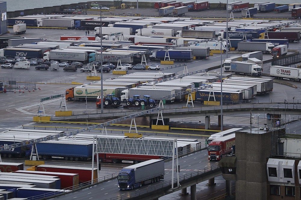 FILE - In this file photo dated Saturday, Feb. 1, 2020, lorries leave after disembarking a ferry as others wait to board on the morning after Brexit took place at the Port of Dover in Dover, England. The British government is expected to water down plans for full border checks on goods coming from the European Union amid economic devastation caused by the coronavirus pandemic, according to new reports Friday June 12, 2020, Michael Gove, the minister in charge of Brexit preparations, will announce a more “pragmatic and flexible” approach to imports. (AP Photo/Matt Dunham, FILE)