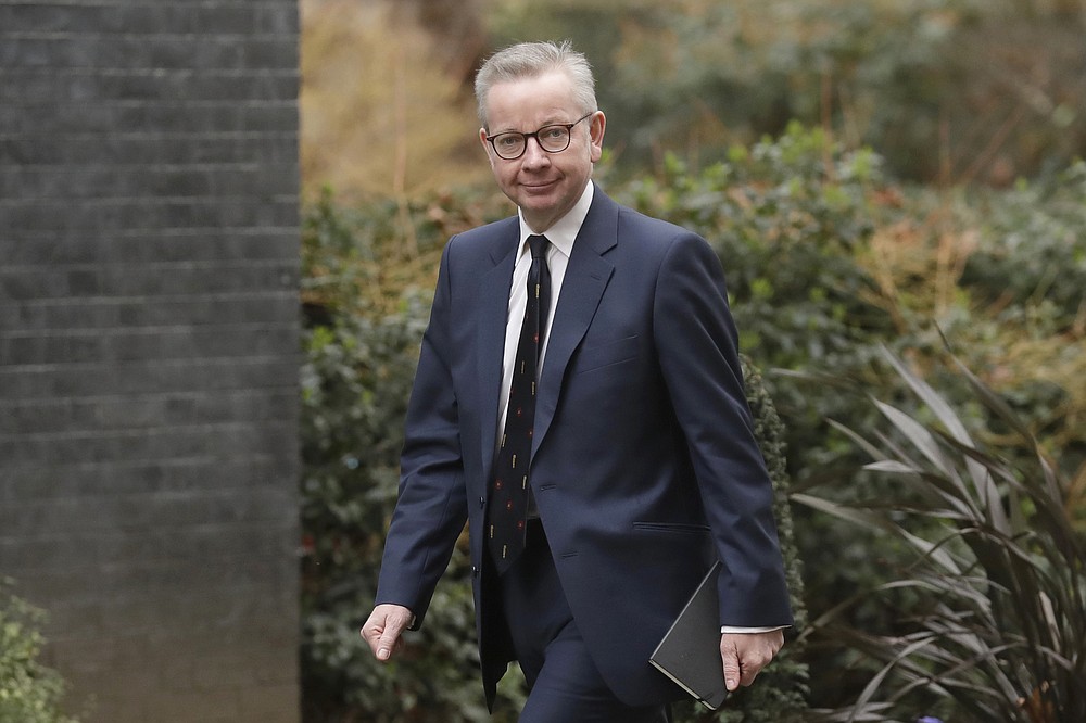 FILE - In this file photo dated Thursday, Feb. 13, 2020, British lawmaker Michael Gove arrives at 10 Downing Street in London. The British government is expected to water down plans for full border checks on goods coming from the European Union amid economic devastation caused by the coronavirus pandemic, according to new reports Friday June 12, 2020, Michael Gove, the minister in charge of Brexit preparations, will announce a more “pragmatic and flexible” approach to imports. (AP Photo/Matt Dunham, FILE)