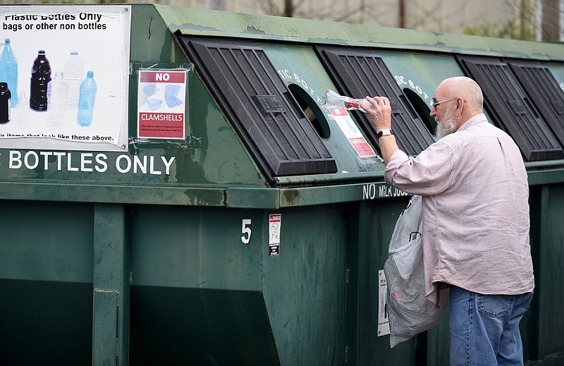 Martin Cox separates his recyclables Monday, at the City of Fayetteville Recycling Drop off on Happy Hollow Road. The City of Fayetteville's Recycling and Trash Collection Division has suspended curbside recycling to help limit community spread of covid-19. More information is available at www.fayetteville-ar.gov/. Check out nwaonline.com/2003224Daily/ and nwadg.com/photos for a photo gallery.
(NWA Democrat-Gazette/David Gottschalk)