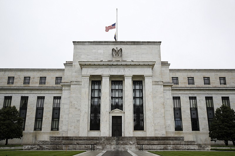 This May 22, 2020 photo shows the Federal Reserve building in Washington. The Federal Reserve said Monday, June 15, 2020 that it will begin purchasing corporate bonds as part of a previously-announced program to ensure companies can borrow through the bond market during the pandemic The program will purchase already-issued bonds on the open market and will seek to build a “broad and diversified” portfolio that will mimic a bond-market index. (AP Photo/Patrick Semansky)