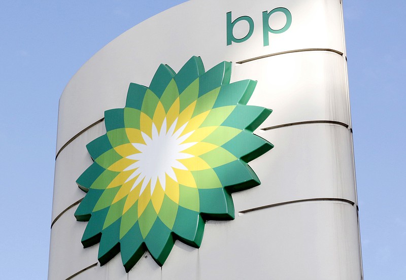 FILE - This Tuesday, Aug. 1, 2017 file photo shows the BP logo at a petrol station in London. Energy company BP is writing off as much as $17.5 billion from its oil and gas assets and will review its plans to develop oil wells as the COVID-19 pandemic accelerates its goal of decreasing its reliance on fossil fuels. (AP Photo/Caroline Spiezio, File)