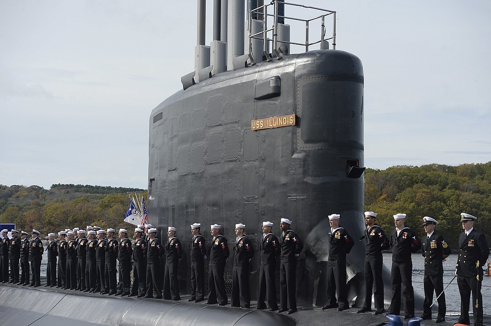FILE - This Oct. 29, 2016 file photo shows the commissioning of the attack submarine USS Illinois as sailors stand atop the sub in Groton, Conn. For decades, the Navy's leading supplier of high-strength steel for submarines provided subpar metal because one of the company's longtime employees falsified lab results, putting sailors at greater risk in the event of collisions or other impacts, federal prosecutors said in court filings Monday, June 15, 2020. The supplier, Kansas City-based Bradken Inc., paid $10.9 million as part of a deferred prosecution agreement, the Justice Department said. The company provides steel castings that Navy contractors Electric Boat and Newport News Shipbuilding use to make submarine hulls. The government did not disclose which subs were affected. (AP Photo/Jessica Hill, File)