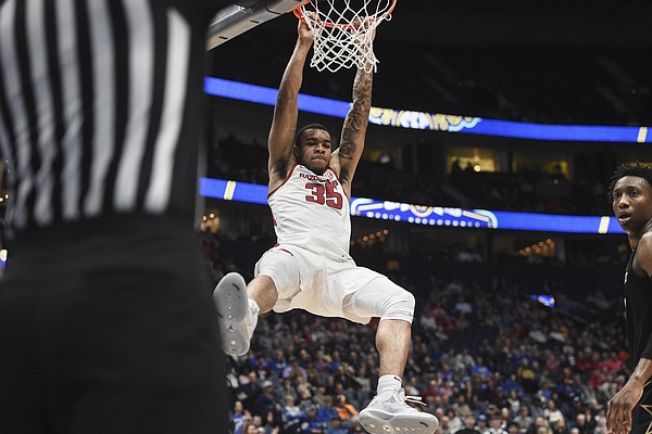 Arkansas forward Reggie Chaney (35) dunks during a March 11 basketball game against Vanderbilt at Bridgestone Arena in Nashville, Tenn. Chaney has entered his name into the transfer portal. - Photo by Charlie Kaijo of NWA Democrat-Gazette