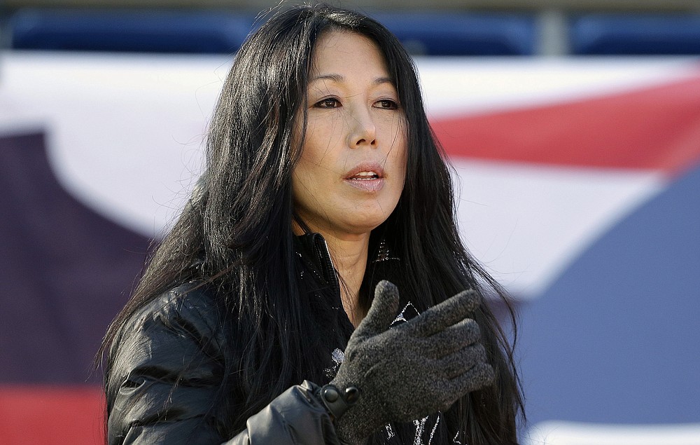 FILE - In this Dec. 23, 2018, file photo, Buffalo Sabres co-owner/president Kim Pegula stands on the field before an NFL football game between the Buffalo Bills and New England Patriots in Foxborough, Mass. Pegula is staying on as Sabres president with a continued focus on making the small-market franchise economically sustainable, while in the face of criticism the team has been mismanaged under her leadership. The team's co-owner told The Associated Press in a recent interview she believes she remains the best-suited for the job to streamline the operation, while acknowledging the process has taken longer than expected. (AP Photo/Steven Senne, File)