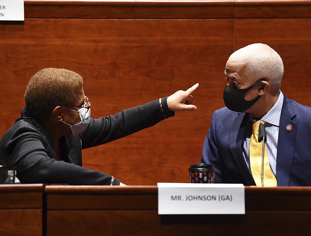 Rep. Karen Bass, D-Calif. left, speaks with Rep. Hank Johnson, D-Ga., during a House Judiciary Committee markup of the Justice in Policing Act of 2020 on Capitol Hill in Washington, Wednesday, June 17, 2020. (Kevin Dietsch/Pool via AP)
