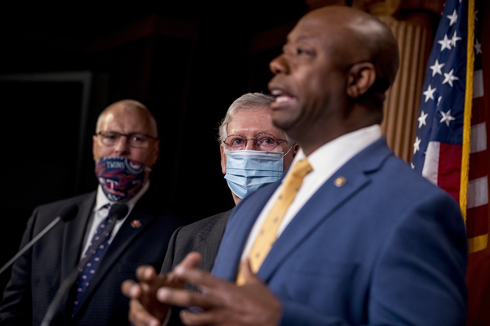 Sen. Tim Scott, R-S.C., right, accompanied by Senate Majority Leader Mitch McConnell of Ky., second from right, and other Republican senators speaks at a news conference to announce a Republican police reform bill on Capitol Hill, Wednesday, June 17, 2020, in Washington. (AP Photo/Andrew Harnik)