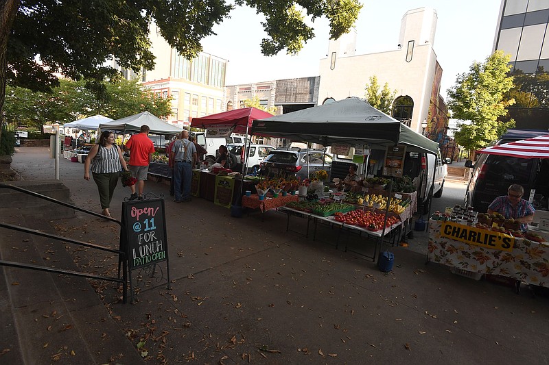 NWA Democrat-Gazette/J.T. WAMPLER Shoppers peruse the offerings at the Fayetteville Farmers Market Thursday Sept. 12, 2019. The City Council on Tuesday will consider a measure that would close Center Street at the square on Saturdays for the Farmers Market, enabling more vendors to set up shop and creating more room for activities.