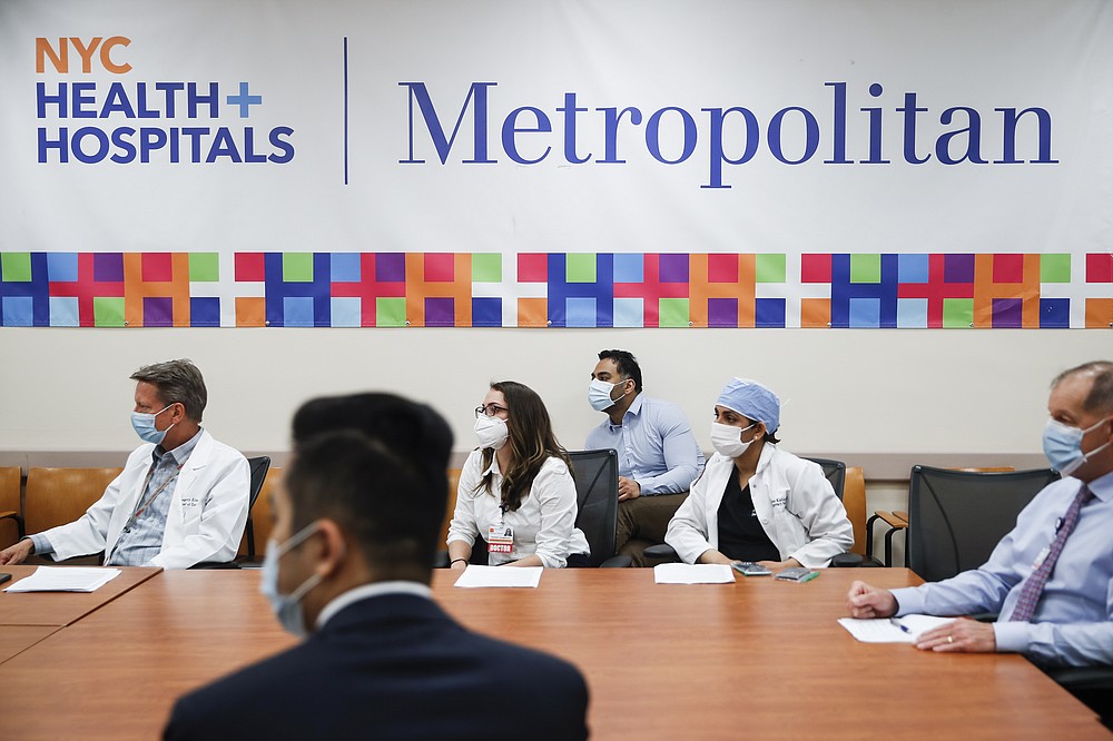 Hospital administrators sit in a meeting at NYC Health + Hospitals Metropolitan, Wednesday, May 27, 2020, in New York. At hospitals around the country, nurses, doctors and other health care workers are reckoning with the psychological toll of the virus fight, coupled with fears that the disease could flare anew later this year. (AP Photo/John Minchillo)