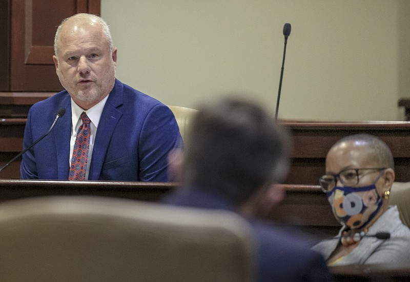 Sen. Jim Hendren, left, asks State Budget Director Jake Bleed, middle, a question Friday June 19, 2020 at the state Capitol in Little Rock during a meeting of the Arkansas Legislative Council. (Arkansas Democrat-Gazette/Staton Breidenthal)