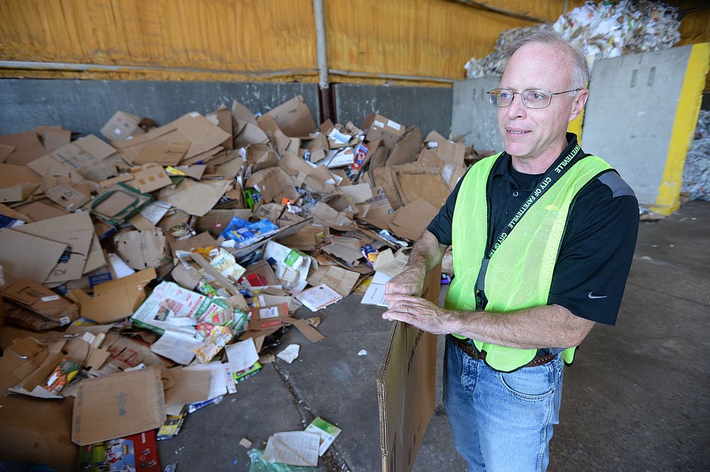 Brian Pugh, Waste Reduction Coordinator for the city of Fayetteville's Recycling and Trash Collection Division, speaks Friday, June 19, 2020, near a pile of corrugated cardboard at the division's facility. Recycling collection during suspension of the curbside program was about 79% of what it was from March to June last year. The city’s curbside service resumes Monday.Visit nwaonline.com/200621Daily/ for today's photo gallery.
(NWA Democrat-Gazette/Andy Shupe)