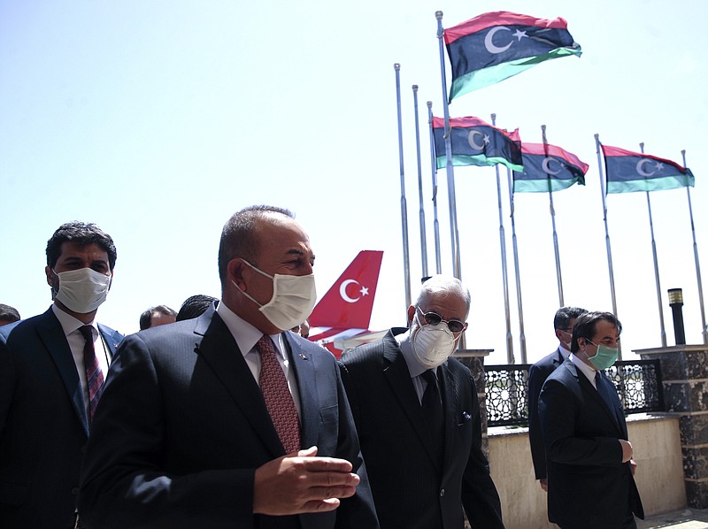 FILE - In this June 17, 2020, file photo, Turkey's Foreign Minister Mevlut Cavusoglu, left, and Muhammed Tahir Siyala, Foreign Minister of Libya's internationally-recognized government, speak at the airport, in Tripoli, Libya. Libya’s eastern-based forces have lost the chance to engage in a political solution to the North African country’s conflict, Turkey's foreign minister said Saturday, June 20, 2020. (Fatih Aktas/Turkish Foreign Ministry via AP, Pool, File)