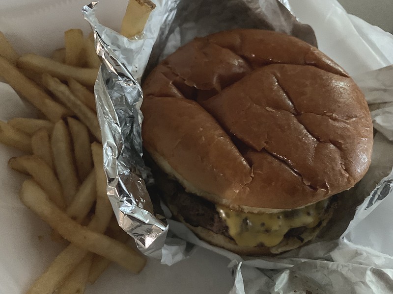 The Steak Knife Three-Cheese Burger from the original Purple Cow on Little Rock's Cantrell Road comes with "our famous fries."
(Arkansas Democrat-Gazette/Eric E. Harrison)