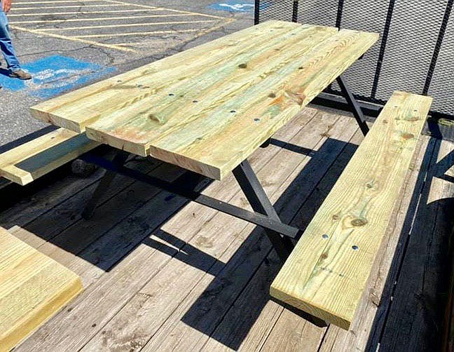 Submitted Photo/MALLORY WEAVER
A picnic table provides seating and a place to enjoy a snack at the Gravette city pool. The table was constructed and donated to the city by students in William Tapp's shop class during the 2019-2020 school year. Shop class members made all the player benches in the dugouts at the baseball fields as well as a few other picnic tables around town. Mr. Tapp retired at the end of the school year after 38 1/2 years of service in the Gravette school district.