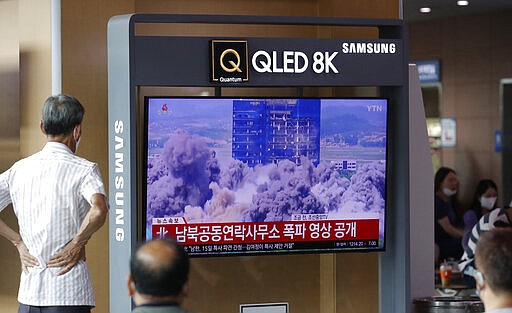 People watch a TV screen showing a news program with video of the demolition of the inter-Korean liaison office building in Kaesong, North Korea, at the Seoul Railway Station in Seoul, South Korea, Wednesday, June 17, 2020. North Korea said Wednesday that it will send soldiers to now-shuttered inter-Korean cooperation sites in its territory and reinstall guard posts and resume military exercises at front-line areas, nullifying tension-reducing deals reached with South Korea just two years ago. The letters read "North Korea, the video of the demolition of the inter-Korean liaison office building." (AP Photo/Lee Jin-man)
