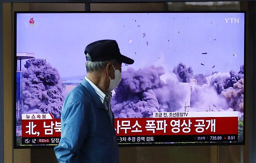 A man watches a TV screen showing a news program with video of the demolition of the inter-Korean liaison office building in Kaesong, North Korea, at the Seoul Railway Station in Seoul, South Korea, Wednesday, June 17, 2020. North Korea said Wednesday that it will send soldiers to now-shuttered inter-Korean cooperation sites in its territory and reinstall guard posts and resume military exercises at front-line areas, nullifying tension-reducing deals reached with South Korea just two years ago. The letters read "North Korea, the video of the demolition of the inter-Korean liaison office building." (AP Photo/Lee Jin-man)
