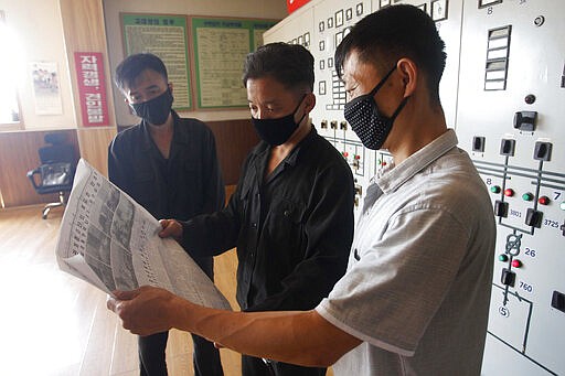 Workers of the Pyongyang Thermal Power Complex read a Rodong Sinmun newspaper story reporting on the demolition of the north-south joint liaison office and the statement of Kim Yo Jong, first vice department director of the Central Committee of the WPK, at the Pyongyang Thermal Power Complex in Pyongyang, North Korea, on Wednesday, June 17, 2020. North Korea said Wednesday it will redeploy troops to now-shuttered inter-Korean cooperation sites, reinstall guard posts and resume military exercises at front-line areas, nullifying the tension-reducing deals reached with South Korea just two years ago. (AP Photo/Jon Chol Jin) story.lead_photo.caption