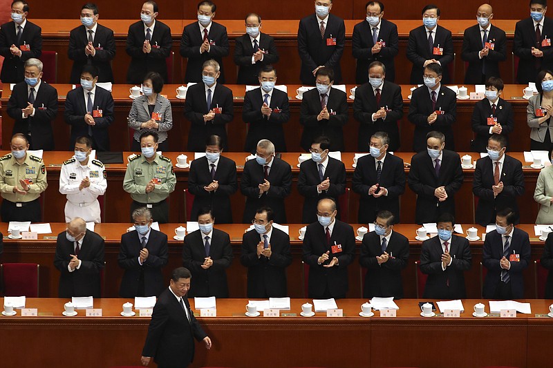 FILE - In this Friday, May 22, 2020 file photo, delegates applaud as President Xi Jinping arrives for the opening session of China's National People's Congress (NPC) at the Great Hall of the People in Beijing. Throughout January, the World Health Organization publicly praised China for what it called a speedy response to the new coronavirus. It repeatedly thanked the Chinese government for sharing the genetic map of the virus “immediately,” and said its work and its commitment to transparency were “very impressive, and beyond words.” But behind the scenes, it was a much different story, one of significant delays by China and considerable frustration among WHO officials over not getting the information they needed to fight the spread of the deadly virus, The Associated Press has found. (AP Photo/Ng Han Guan, Pool)