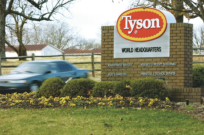 FILE - In this Jan. 29, 2006, file photo, a car passes in front of a Tyson Foods Inc., sign at Tyson headquarters in Springdale, Ark. China's decision to ban imports from a single Tyson Foods poultry plant because of concerns about a coronavirus outbreak there puzzled many in the meat industry and raised concerns about whether this could threaten a major market for U.S. meat. The action China's customs agency took against the Tyson plant in Springdale, Arkansas, could have major implications for the meat industry if it were expanded because dozens of beef, pork and poultry plants have had outbreaks of the coronavirus among their workers.(AP Photo/April L. Brown, File)