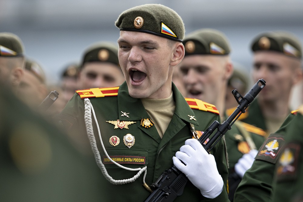 FILE - In this file photo taken on Saturday, June 20, 2020, a Russian soldier sings a combat song as he marches toward Red Square to attend a dress rehearsal for the Victory Day military parade in Moscow, Russia. A massive military parade that was postponed by the coronavirus will roll through Red Square this week to celebrate the 75th anniversary of the end of World War II in Europe, even though Russia is continuing to register a steady rise in infections. (AP Photo/Alexander Zemlianichenko, File)