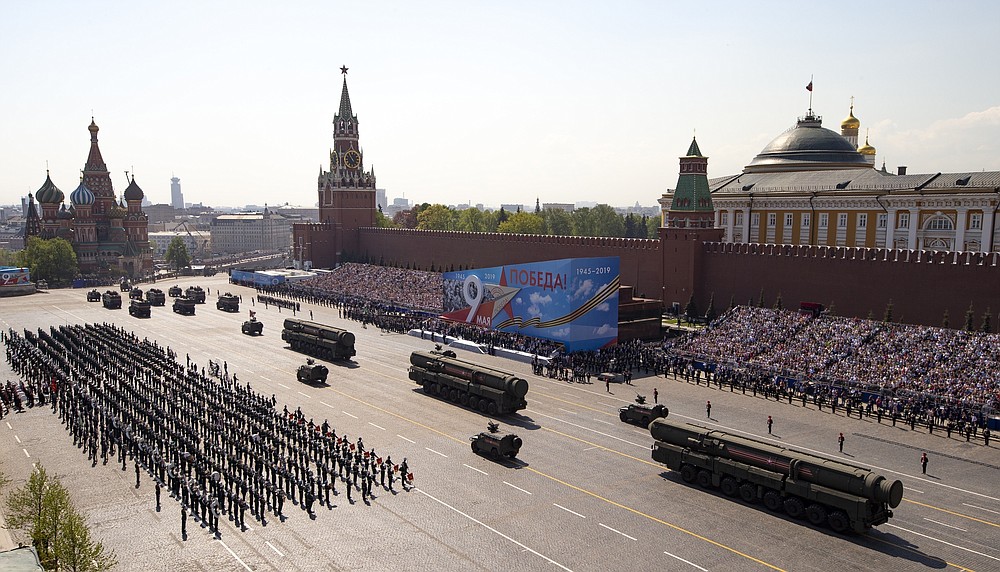 FILE - In this Tuesday, May 7, 2019 file photo, Russian military vehicles roll down Red Square Red Square during a rehearsal for the Victory Day military parade in Moscow, Russia. A massive military parade that was postponed by the coronavirus will roll through Red Square this week to celebrate the 75th anniversary of the end of World War II in Europe, even though Russia is continuing to register a steady rise in infections. (AP Photo/Alexander Zemlianichenko, Pool, File)