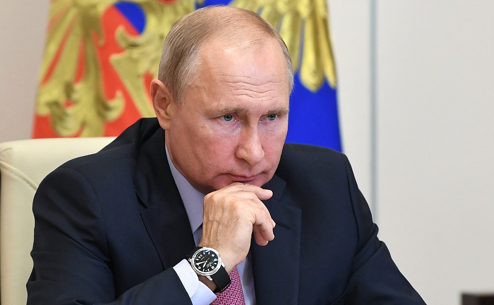 FILE - In this Tuesday, June 9, 2020 file photo, Russian President Vladimir Putin attends a meeting with Sberbank chairman German Gref via video conference at the Novo-Ogaryovo residence outside Moscow, Russia. A massive military parade that was postponed by the coronavirus will roll through Red Square this week to celebrate the 75th anniversary of the end of World War II in Europe, even though Russia is continuing to register a steady rise in infections. (Alexei Nikolsky, Sputnik, Kremlin Pool Photo via AP, File)
