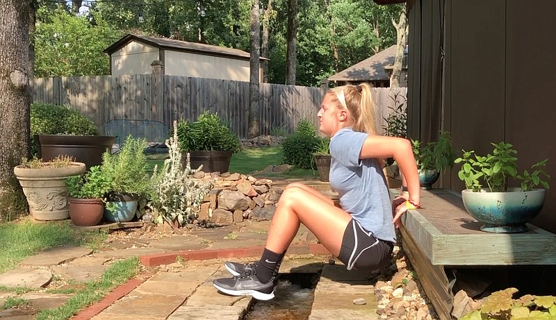 Meredith Pinkston demonstrates that Porch Dips can be done in many settings, including on a bench in her back yard.  (Arkansas Democrat-Gazette/Celia Storey)