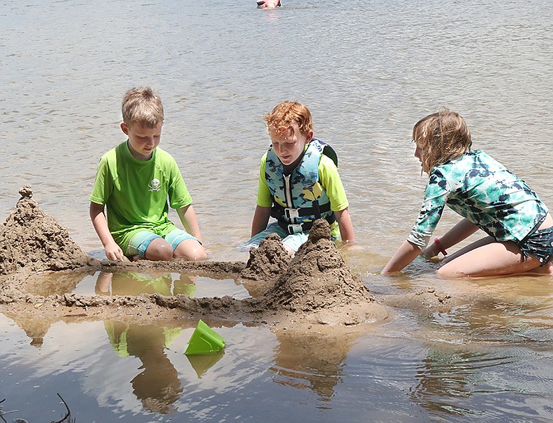 From left, David Boch, 6, Thomas Boch, 8, and Charlotte Boch, 10, all of Little Rock, build a sandcastle at DeGray Lake’s Highway 7 recreation area on Thursday. - Photo by Richard Rasmussen of The Sentinel-Record