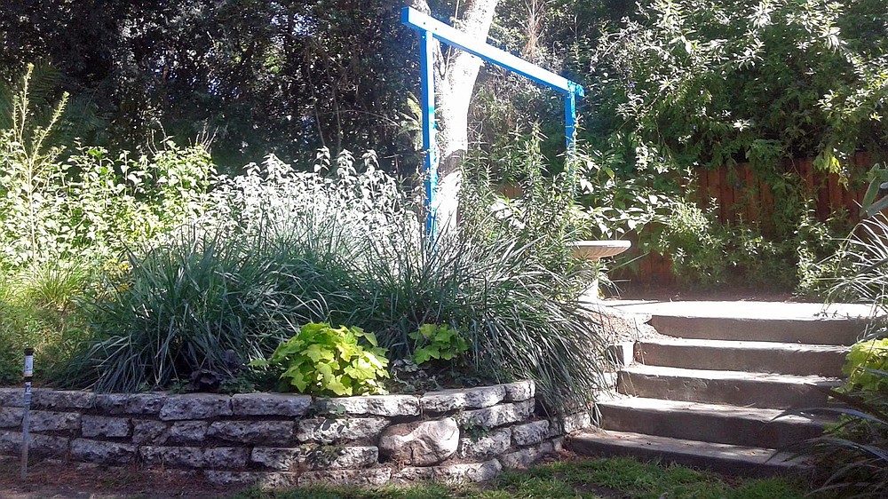 In this 2012 photo provided by Los Angeles landscape designer Katharine Pinney, a garden wall is shown at a home in Altadena, Calif. Pinney built the wall for a client from stone and concrete already on the site. Homeowners can transform an ordinary looking landscape with some imagination, design, and perhaps the help of a local agriculture extension service, landscape professional or private nursery. (Katharine Pinney via AP)