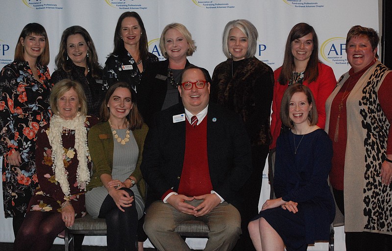 NWA Democrat-Gazette/JOCELYN MURPHY Alison Levin (seated, from left), Eva Terry, Tyler Clark, Ashley Wardlow, Elizabeth Prenger (standing, from left), Cindy Long, Emily Rappe Fisher, Megan Cuddy, Jaclyn Keeter, Sarah Du Preez and Allison McElroy, AFP Northwest Arkansas board members, welcome guests to the National Philanthropy Day luncheon Nov. 14 at the Fayetteville Town Center.