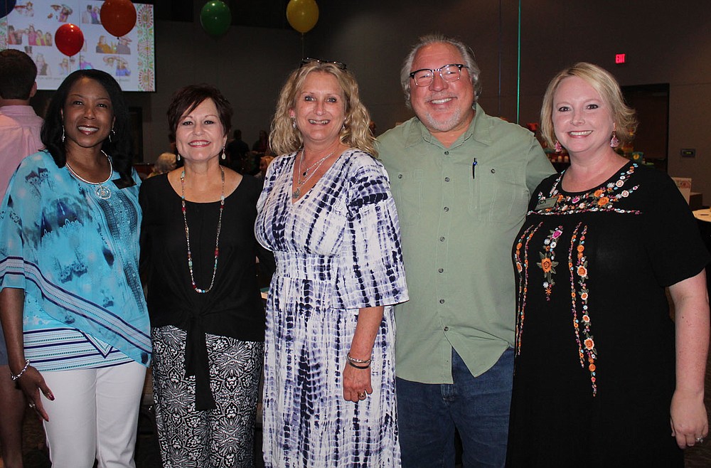 NWA Democrat-Gazette/CARIN SCHOPPMEYER Delia Anderson Farmer, Children's House executive director (from left), Julie Parker, Vickie and Mike Lanier and Megan Cuddy visit at Summer Salsa on June 15 at the Fayetteville Town Center.