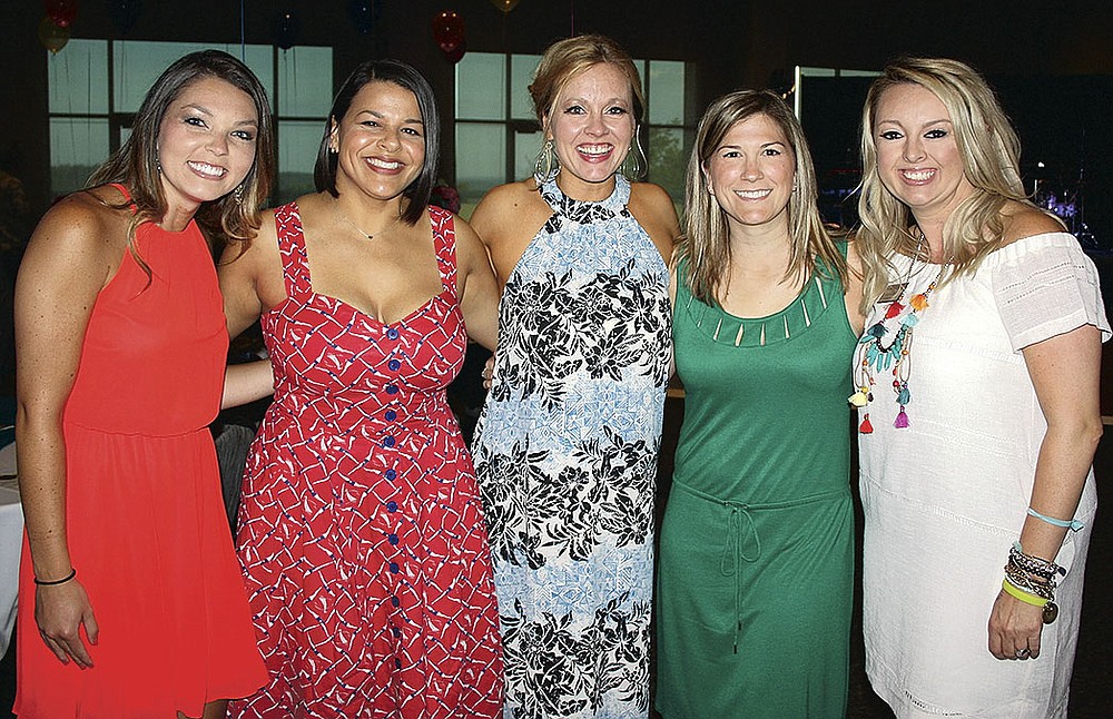 NWA Democrat-Gazette/CARIN SCHOPPMEYER Falon Lacey (from left), Christina Sutton, Brittany Adcock and Gracie Ziegler volunteer at Summer Salsa on June 18 at the Fayetteville Town Center.
