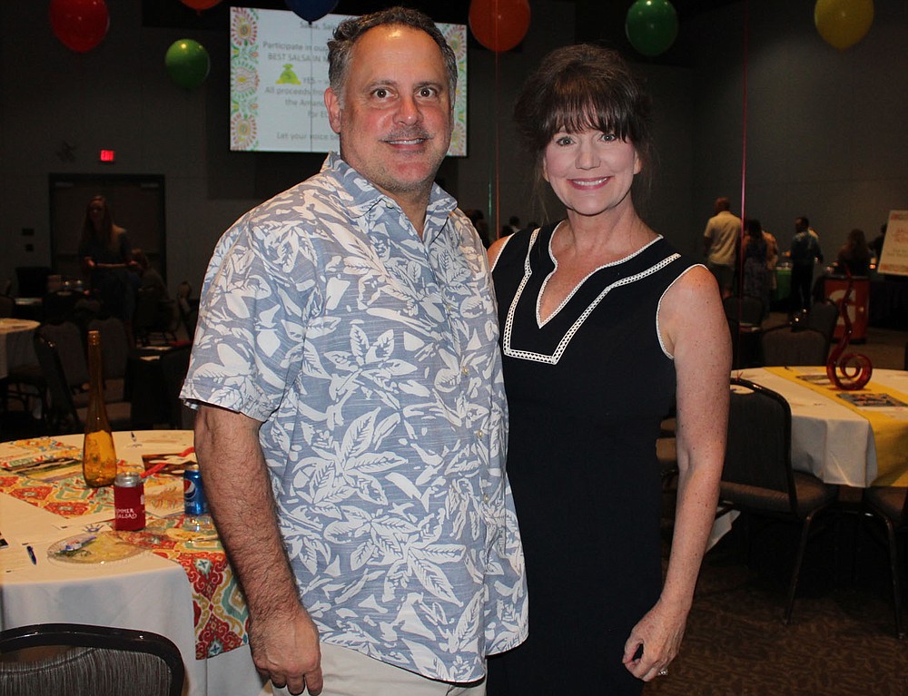 NWA Democrat-Gazette/CARIN SCHOPPMEYER Sean Jones and Judge Stacey Zimmerman help attend Summer Salsa.