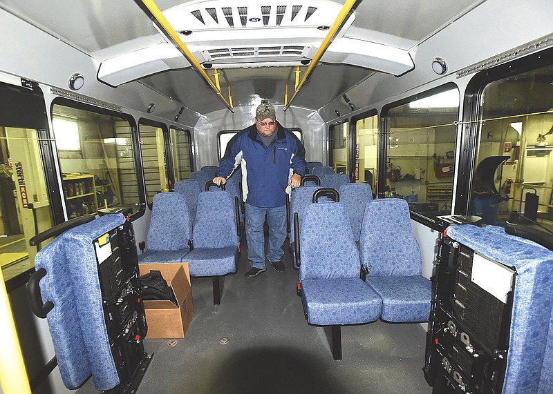 NWA Democrat-Gazette/FLIP PUTTHOFF
John Williams, transit coordinator at Ozark Regional Transit, inspects Saturday Jan. 13 2018 a new bus delivered to ORT in Springdale on Saturday morning. The bus was driven to ORT from the factory in Indiana. It is one of eight new buses ORT will receive.