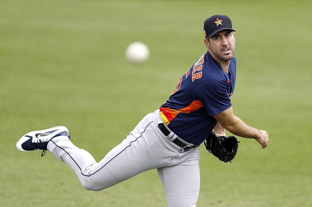 FILE - In this March 3, 2020, file photo, Houston Astros pitcher Justin Verlander warms up prior to the team's spring training baseball game against the St. Louis Cardinals in Jupiter, Fla. Verlander has resumed throwing as he recovers from March groin surgery. Houston manager Dusty Baker said Wednesday, April 15, that Verlander, who had surgery on March 17, is “doing great" and is throwing as he continues his rehabilitation. (AP Photo/Julio Cortez, File)