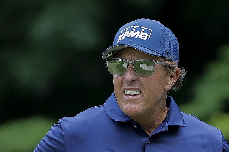 Phil Mickelson looks on after putting on the 14th green during the second round of the Travelers Championship on Friday at TPC River Highlands in Cromwell, Conn. Mickelson shot a 7-under 63 to take a one-stroke lead into today’s third round.
(AP/Frank Franklin II)