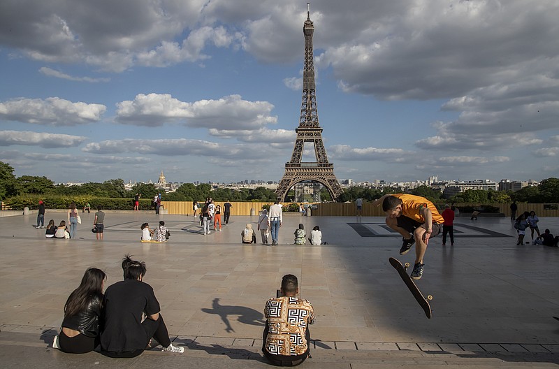 In this May 25 file photo, people stroll at Trocadero square near the Eiffel Tower in Paris. European Union envoys are close to finalizing a list of countries whose citizens will be allowed back into Europe once it begins lifting coronavirus-linked restrictions. The United States appears almost certain not to make the list, as new infections surge and given that President Donald Trump has imposed a ban on European travelers. - AP Photo/Michel Euler story.lead_photo.caption