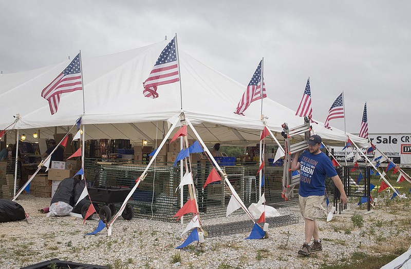 Adam Keeley sets up his fire works stand, Saturday, June 27, 2020 at Pinnacle Fireworks in Springdale. "I know a lot of the big professional city displays have been been cancelled so this seems to be the year for the backyard fire works show," said Adam Keeley who owns the fire works stand and manages it with his mom and dad. "I've got a lot of friends in the industry and other parts of the country and they're local ordinance is opening before me. They said their business is absolutely booming. It's going to be the best year they've had, so we prepared by buying lots of fireworks this year. Springdale will allow fireworks sales starting on Sunday. Check out nwaonline.com/200628Daily/ for today's photo gallery. 
(NWA Democrat-Gazette/Charlie Kaijo)