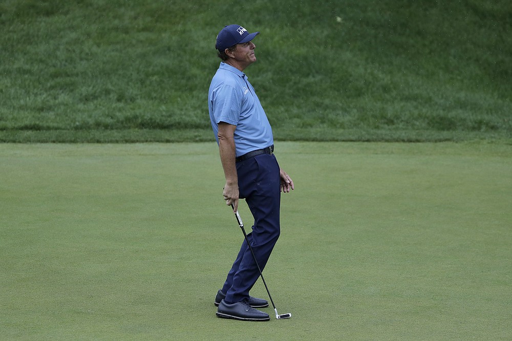 Phil Mickelson reacts after missing a putt on the 18th green during the third round of the Travelers Championship golf tournament at TPC River Highlands, Saturday, June 27, 2020, in Cromwell, Conn. (AP Photo/Frank Franklin II)