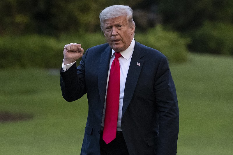 President Donald Trump pumps his fist as he walks on the South Lawn after arriving on Marine One at the White House on Thursday in Washington after returning from Wisconsin. - AP Photo/Alex Brandon story.lead_photo.caption