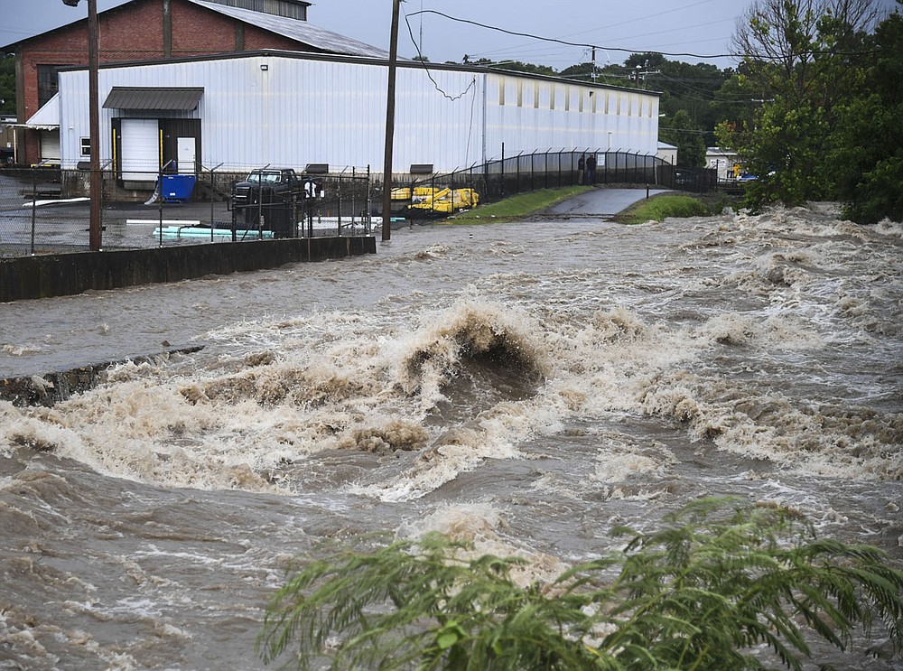 Hot Springs Creek rushes over the Hot Springs Creek Greenway Trail near the Valley Street Skatepark on Monday. - Photo by Grace Brown of The Sentinel-Record