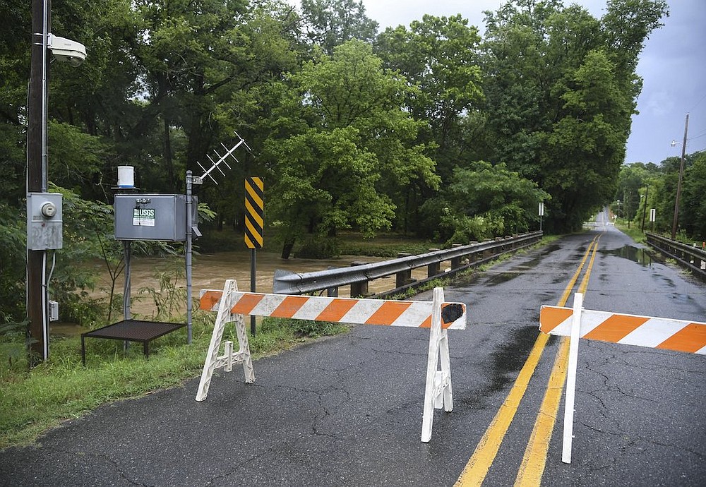 Barricades block a bridge on Ridgeway Street due to high water from Gulpha Creek on Monday, June 29, 2020, after heavy rains. - Photo by Grace Brown of The Sentinel-Record