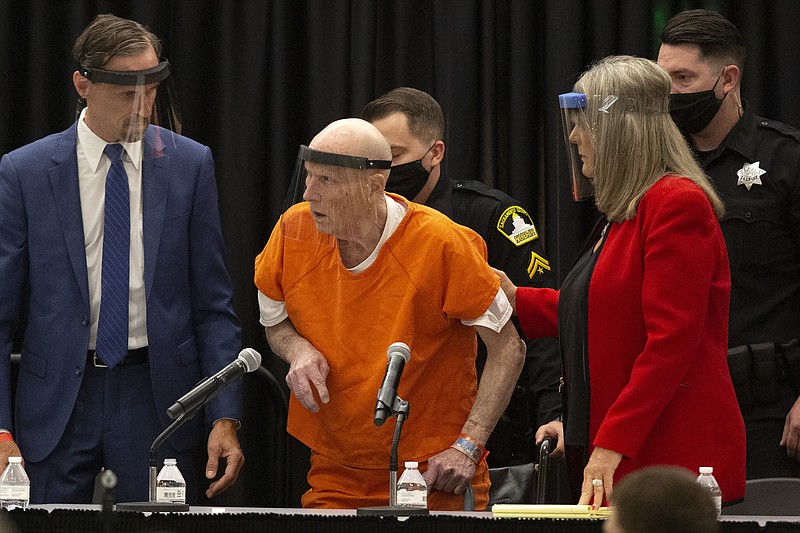 Joseph James DeAngelo, center, charged with being the Golden State Killer, is helped up by his attorney, Diane Howard, as Sacramento Superior Court Judge Michael Bowman enters the courtroom in Sacramento, Calif., Monday June 29, 2020. DeAngelo pleaded guilty to multiple counts of murder and other charges 40 years after a sadistic series of assaults and slayings in California. Due to the large numbers of people attending, the hearing was held at a ballroom at California State University, Sacramento to allow for social distancing. (AP Photo/Rich Pedroncelli) story.lead_photo.caption