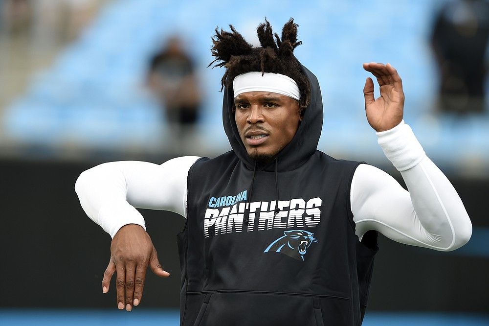 FILE - In this Sept. 12, 2019, file photo, Carolina Panthers quarterback Cam Newton warms up prior to the team's NFL football game against the Tampa Bay Buccaneers in Charlotte, N.C. The New England Patriots have reached an agreement with free-agent quarterback Newton, bringing in the 2015 NFL Most Valuable Player to help the team move on from three-time MVP Tom Brady, a person with knowledge of the deal told The Associated Press. (AP Photo/Mike McCarn, File)
