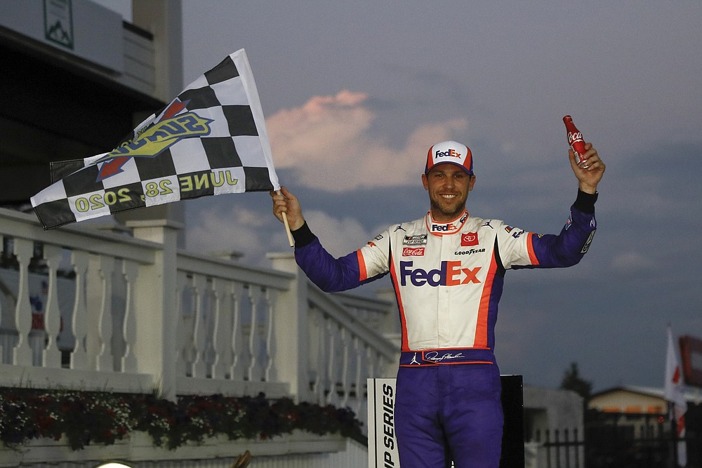 Denny Hamlin smiles after winning the NASCAR Cup Series auto race at Pocono Raceway, Sunday, June 28, 2020, in Long Pond, Pa. (AP Photo/Matt Slocum)