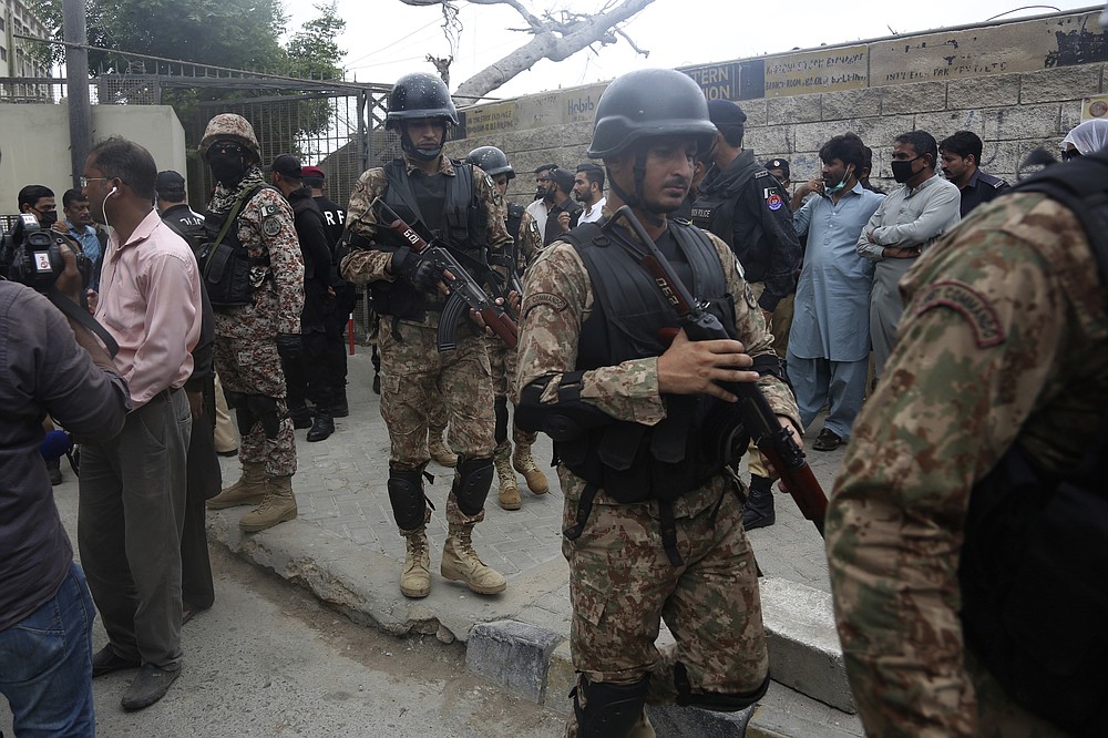 Security personnel surround the Stock Exchange Building after gunmen's attack in Karachi, Pakistan, Monday, June 29, 2020. Special police forces deployed to the scene of the attack and in a swift operation secured the building. (AP Photo/Fareed Khan)