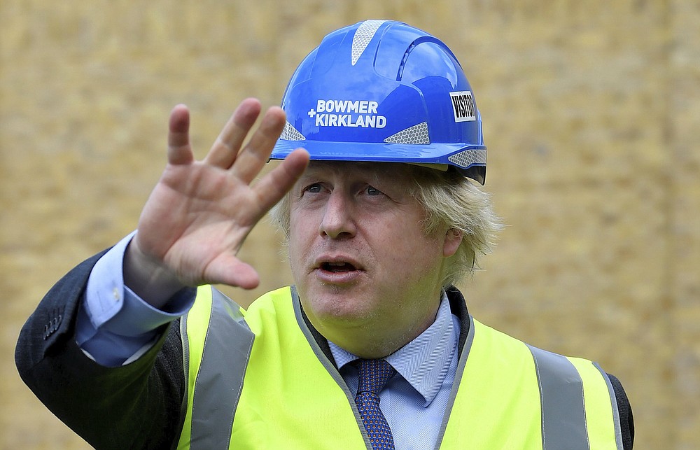 Britain's Prime Minister Boris Johnson visits the construction site of Ealing Fields High School in west London, Monday June 29, 2020. (Toby Melville/Pool via AP)